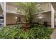 Interior courtyard with lush greenery, a fountain, and architectural details at 3325 Bayshore Blvd # C36, Tampa, FL 33629