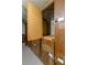 Wooden storage unit in a concrete room featuring a partially open door revealing interior space at 3325 Bayshore Blvd # C36, Tampa, FL 33629