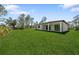 Large backyard with green grass, and covered patio at 3344 Lagoy St, North Port, FL 34291