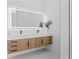 Spacious bathroom with double sink vanity, sleek cabinets, illuminated mirror and modern fixtures at 3344 Lagoy St, North Port, FL 34291