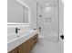 Modern bathroom featuring sleek vanity, LED mirror, and a tiled shower-tub combination at 3344 Lagoy St, North Port, FL 34291