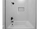 Bright tub/shower with white tile surround and decorative niche at 3344 Lagoy St, North Port, FL 34291