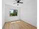 Bright bedroom with hardwood floors and large window overlooking the backyard at 3344 Lagoy St, North Port, FL 34291