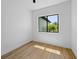 Bedroom with wood floors, white walls, ceiling fan, and a bright window view at 3344 Lagoy St, North Port, FL 34291