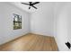 Bedroom with hardwood floors, white walls, and natural light from a window at 3344 Lagoy St, North Port, FL 34291