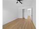 Bright bedroom with wood-look floors, closet, ceiling fan, and white walls at 3344 Lagoy St, North Port, FL 34291