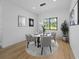 Modern dining room features trendy light fixtures and a view to the backyard at 3344 Lagoy St, North Port, FL 34291