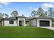 New construction home with green lawn, and paver driveway at 3344 Lagoy St, North Port, FL 34291
