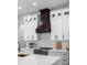 Modern kitchen featuring granite countertops, white cabinets, and a high-end range hood at 3344 Lagoy St, North Port, FL 34291