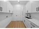 Bright laundry room features white cabinets, modern hardware, and ample storage at 3344 Lagoy St, North Port, FL 34291