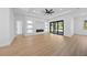 Bright living room with recessed lighting, a modern fireplace, and sliding glass doors to the patio at 3344 Lagoy St, North Port, FL 34291
