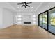 Open living room featuring recessed lights, a modern fireplace, and sliding glass doors to the patio at 3344 Lagoy St, North Port, FL 34291