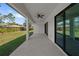 Covered patio with ceiling fan, sliding glass doors, and view of the backyard at 3344 Lagoy St, North Port, FL 34291