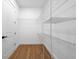 Walk-in closet with a door, shelving, and wood floors to organize your wardrobe at 3344 Lagoy St, North Port, FL 34291