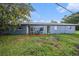 Back exterior view showing painted home with two entrances and lawn at 3404 Dahlia Pl, Largo, FL 33771