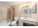 Bathroom featuring tiled walls, and a shower-tub combo at 3404 Dahlia Pl, Largo, FL 33771