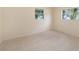 A cozy bedroom featuring tile flooring and windows that let in natural light at 3404 Dahlia Pl, Largo, FL 33771