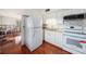 Modern kitchen with white cabinets, stainless steel appliances, and unique tile backsplash at 3404 Dahlia Pl, Largo, FL 33771