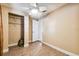 Bedroom features wood flooring, ceiling fan, and a closet for storage at 3414 Whittier St, Tampa, FL 33619