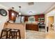 Open kitchen featuring stainless steel appliances, granite countertops, and dark wood cabinetry with barstool seating at 3414 Whittier St, Tampa, FL 33619