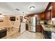 Open kitchen featuring stainless steel appliances, granite countertops, and dark wood cabinetry, seamlessly flowing into living area at 3414 Whittier St, Tampa, FL 33619