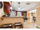 Open kitchen featuring stainless steel appliances, granite countertops, dark wood cabinetry, and barstool seating at 3414 Whittier St, Tampa, FL 33619