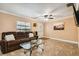 Comfortable living room features tile flooring, a ceiling fan, and a cozy seating area at 3414 Whittier St, Tampa, FL 33619