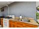 Outdoor kitchen features granite countertops, wood cabinets, and a stainless steel sink at 3414 Whittier St, Tampa, FL 33619