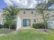Backyard with a patio, white fence, trees, and grass at 34187 Rogallo Ln, Wesley Chapel, FL 33545
