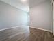 Bedroom featuring wood-look laminate floors, neutral walls, and a closet at 34187 Rogallo Ln, Wesley Chapel, FL 33545