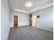 Spacious main bedroom with tray ceiling, wood floors and walk-in closet, providing a private and comfortable space at 34187 Rogallo Ln, Wesley Chapel, FL 33545