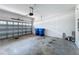 Garage with a garage door, trash cans, and paint cans at 34187 Rogallo Ln, Wesley Chapel, FL 33545