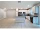 Modern kitchen featuring stainless steel appliances, granite countertops, an island, and white cabinets in an open layout at 34187 Rogallo Ln, Wesley Chapel, FL 33545