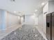 Modern kitchen island with gray granite countertops, stainless steel appliances and lights surrounded by an open floor plan at 34187 Rogallo Ln, Wesley Chapel, FL 33545