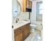 Well-lit bathroom with a modern vanity, updated fixtures, and tiled walls at 4103 Gulf Blvd # 210, St Pete Beach, FL 33706