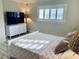 Comfortable bedroom featuring a dresser, a TV, and natural light from the window at 4103 Gulf Blvd # 210, St Pete Beach, FL 33706