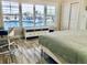Bedroom showcasing a large window with plantation shutters providing stunning water views at 4103 Gulf Blvd # 210, St Pete Beach, FL 33706