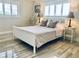 Serene bedroom featuring a comfortable bed, neutral decor, and natural light from the windows at 4103 Gulf Blvd # 210, St Pete Beach, FL 33706
