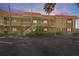 Charming two-story condo building with a red tile roof, large palm trees, and well-maintained landscaping at 4103 Gulf Blvd # 210, St Pete Beach, FL 33706