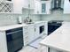 Updated kitchen features stainless appliances, white cabinetry, marble countertops and wine rack above the dishwasher at 4103 Gulf Blvd # 210, St Pete Beach, FL 33706