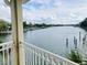 Stunning water view from the balcony, overlooking the serene bay and boat docks on a sunny day at 4103 Gulf Blvd # 210, St Pete Beach, FL 33706