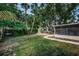 Lush backyard with tropical plants, a deck, and ample room for outdoor activities and entertaining at 4106 W Fielder St, Tampa, FL 33611