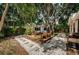 Lovely backyard offers relaxation and entertainment with a deck, firepit and hammock at 4106 W Fielder St, Tampa, FL 33611