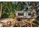 Backyard with deck, firepit, and hammock providing a beautiful outdoor living space at 4106 W Fielder St, Tampa, FL 33611
