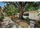 Backyard with pavers leading to a deck, firepit, and hammock, perfect for outdoor living at 4106 W Fielder St, Tampa, FL 33611