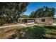 Spacious backyard with a wooden deck, hammock, and a screened lanai for outdoor enjoyment at 4106 W Fielder St, Tampa, FL 33611