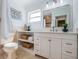 Bright bathroom features a white vanity, baskets for storage and a modern mirror at 4106 W Fielder St, Tampa, FL 33611