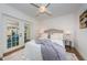 Cozy bedroom featuring French doors leading to the outdoors, soft lighting, and a plush bed at 4106 W Fielder St, Tampa, FL 33611