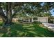 Charming one-story brick home with lush lawn and mature trees providing ample shade and curb appeal at 4106 W Fielder St, Tampa, FL 33611