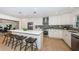 Modern kitchen featuring white cabinets, stainless steel appliances, large island with seating at 4106 W Fielder St, Tampa, FL 33611